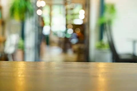 Soft focus background of wooden table and bokeh in cafe shop. Stock Photos