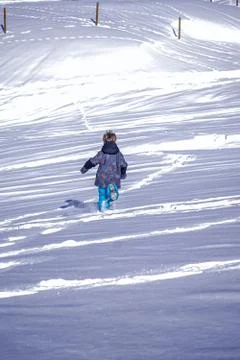 Soft focus background . Young Boy Runs Away Into The Snow Stock Photos