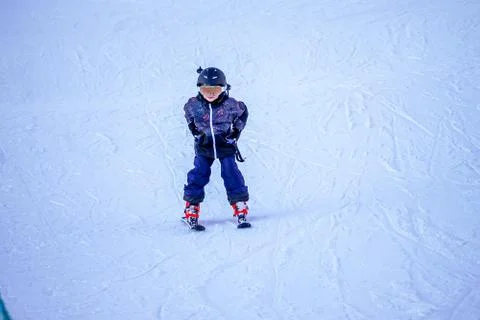Soft focus background. Young boy skiing downhill in ski resort. Foto stock