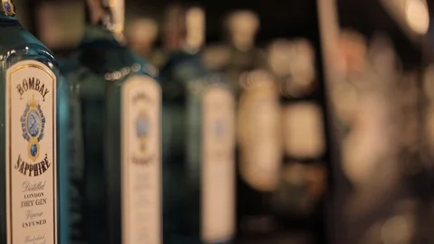 Soft Focus of Bombay Gin Blue Bottles in the Pub Stock Footage 129703813