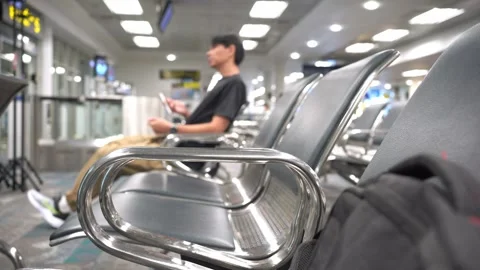 Soft focus business concept with man sit on chair and work with seat in airport Stock Footage 290490134