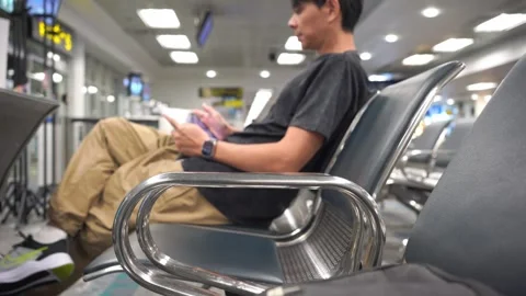 Soft focus business concept with man sit on chair and work with seat in airport Stock Footage 290490161