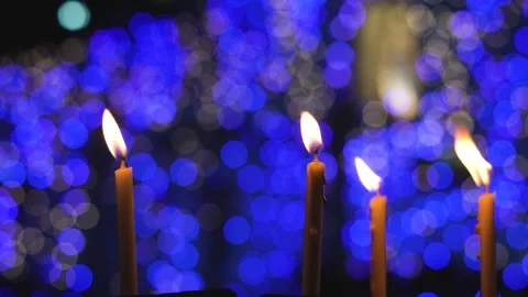 Soft Focus Candle Flames with Blue Decorative Lights Background 스톡 동영상 327400169