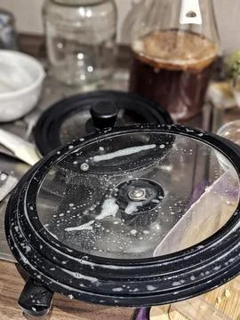 Soft Focus Capturing Cozy Meal Preparation. Convection Lid Collects Moistur.. Stock Photos