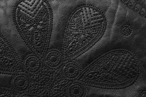 Soft focus close up detail of  thread embroidery design on black genuine le.. Foto stock