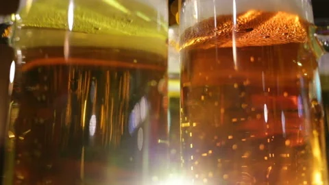 Soft focus, close-up of gas bubbles in ale glasses. Real-time, evening in the ba Stock Footage 87426422