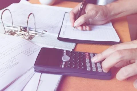 Soft focus, close up of man with using counting making notes with calculato.. Stock Photos