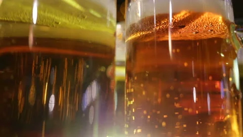 Soft focus, close-up. Two glasses with ale in glass glasses stand nearby. Real-t Stock Footage 87425627