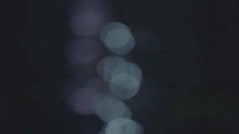 Soft focus coloured lights reflect off river Video stock 244657733