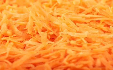 Soft focus. Full frame of grated carrots. Stock Photos