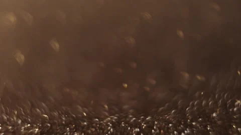 Soft-focus gold glitter bokeh in 4K, creating a cozy Christmas atmosphere. Vídeo Stock 292825795