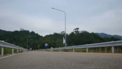 Soft focus on ground floor asphalt street and  blurred defocus footage of run Stock Footage 98571977