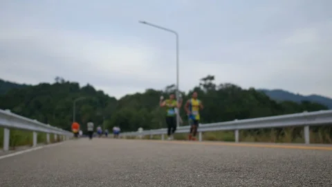 Soft focus on ground floor asphalt street and  blurred defocus footage of run Video stock 98590657