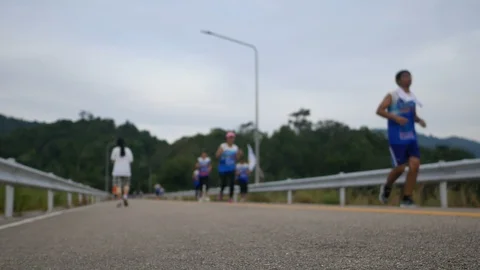 Soft focus on ground floor asphalt street and  blurred defocus footage of run Video stock 98590994
