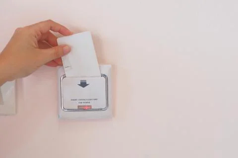 Soft Focus on Hand insert key card for on power electric equipment Stock Photos