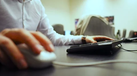Soft focus to hand of the man clicking mouse button and typing Stock Footage 67225737