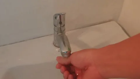 Soft Focus Hand Washing Under Chrome Faucet in Bathroom Sink Stock Footage 346361227