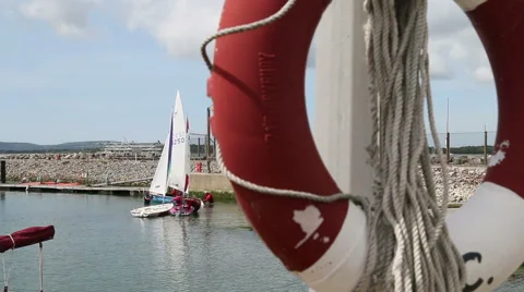 Soft focus lifebouy in foreground sharp dinghies in back Stock Footage 51255636