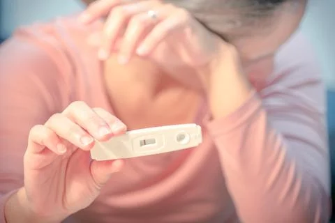 Soft focus on the negative pregnancy test result hold on sad women hand Stock Photos
