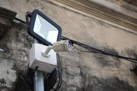 Soft focus of old Led spotlight and old id ahd camera on wall Stock Photos