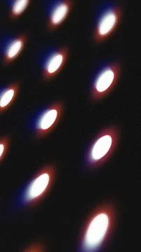 Soft-focus oval bokeh lights on a dark background with red and blue glow, c.. Stock Illustration