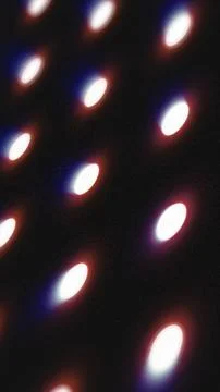 Soft-focus oval bokeh lights on a dark background with red and blue glow, c.. Stock Illustration