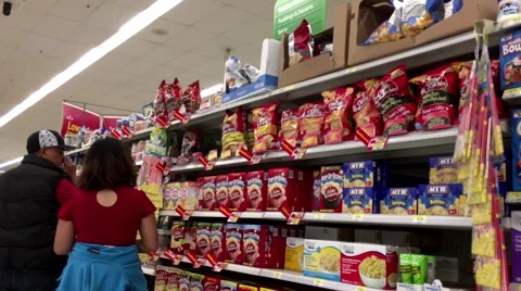 Soft focus of people looking for popcorn products in Walmart store Stock Footage 65052514
