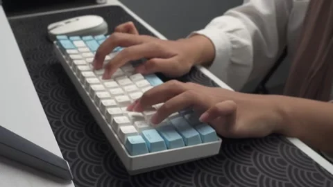 Soft focus of person typing on wireless keyboard on desk Stock Footage 276636420