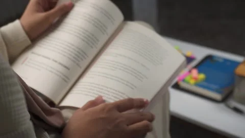 Soft focus of reading books on laps Stock Footage 276932854