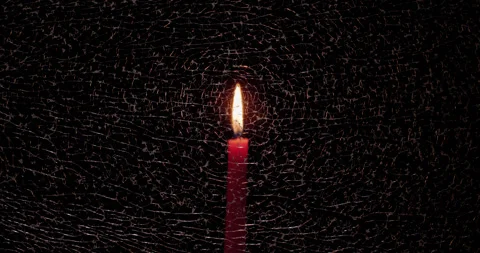 Soft focus red candle visible through a pane of in focus fractured/broken glass. Stock Footage 339026664