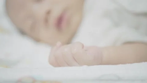 Soft Focus of a Sleeping Baby's Hand Stock Footage 318629320