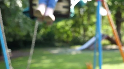 Soft Focus Slow motion anonymous female On Swing Stock Footage 77013735