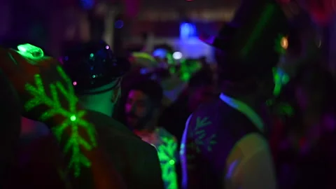 Soft focus slow motion of people dancing masked in a nightclub Stock Footage 220450869
