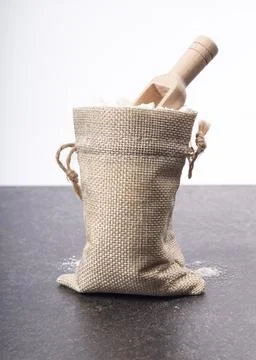 Soft focus. a small bag made of retro-style drape. there is a spoon for spice Stock Photos