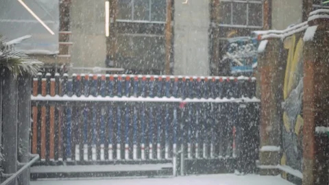 Soft focus snow with graffiti in background, East London Video stock 86478361