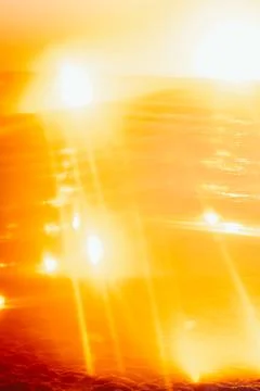 Soft focus. Sunset over ocean waves at beach with golden reflections during l Stock Photos