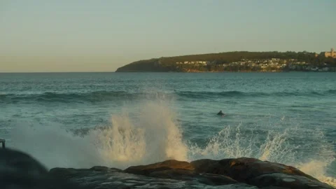 Soft focus surfers and exploding wave just before sunset slow motion 4K Stock Footage 258094979