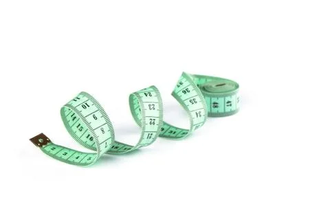 Soft focus. Tailoring centimeter tape twisted into a spiral isolated on a whi Stock Photos