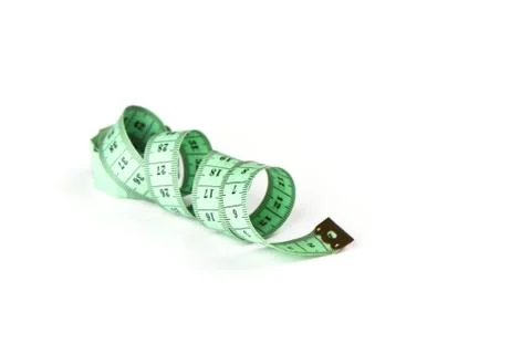 Soft focus. Tailoring centimeter tape twisted into a spiral isolated on a whi Stock Photos