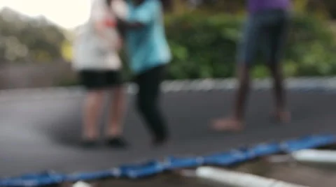 Soft focus of three various race children jumping on a trampoline Stock Footage 57234421