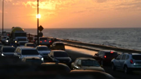 Soft focus of traffic jam on a coastal road at sunset Stock Footage 126549816