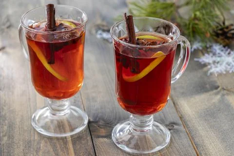 Soft focus on two glasses of hot spicy punch with cinnamon sticks, star anise Stock Photos