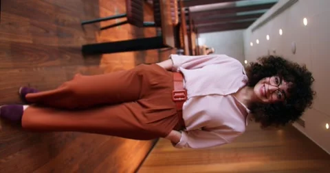 Soft focus Vertical video portrait of happy curly haired and glasses girl Stock Footage 307561999