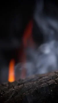 Soft focus view of flame and smoke above burning wood Stock Photos
