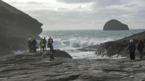 Soft Focus, Wave Watching at High Water at the rocky gully of Trebarwith Strand Stock Footage 86486013