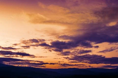 Soft focus winter last sunset high up on the silhouette mountains Stock Photos