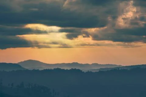 Soft focus winter sunset high up on the silhouette mountains Stock Photos