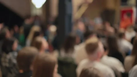 Soft-focused audience attentively observes tech presentation. Image hints at Stock Footage 269004902