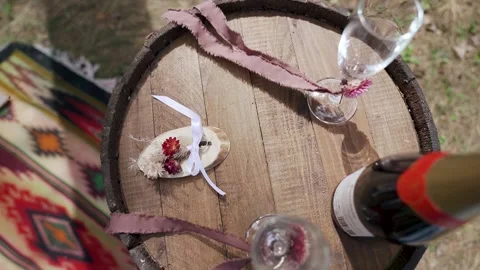 Soft focused beautiful wedding rings with champagne glasses on barrel. Slowmo Stock Footage 204928725