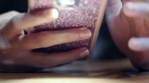 Soft focused browsing smartphone, turns flashlight on and off Stock Footage 61192574